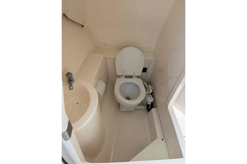 Slide: The Image of Compact marine bathroom in 2012 Pursuit DC 265 Dual Console boat. - 13