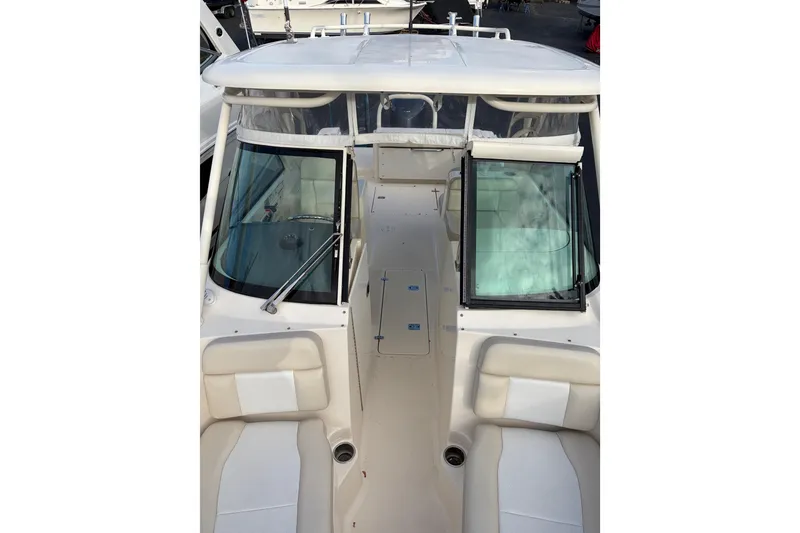 Slide: The Image of 2012 Pursuit DC 265 Dual Console boat interior with seating and windshield. - 3