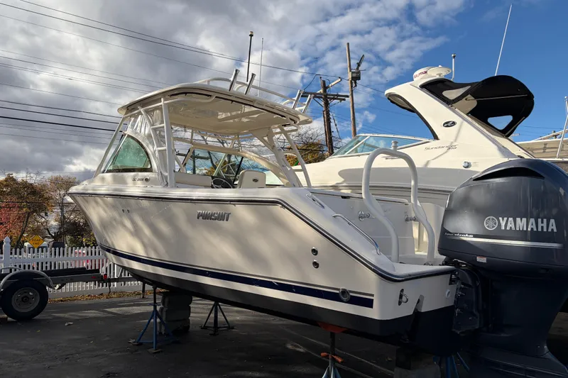 Slide: The Image of 2012 Pursuit DC 265 Dual Console boat with Yamaha engine, parked outdoors. - 7