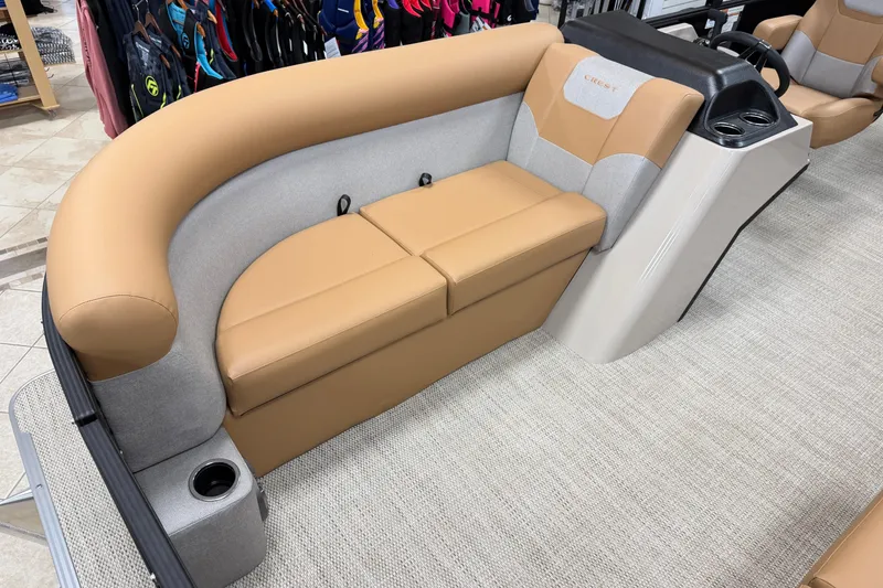 Slide: The Image of 2026 Crest Conquest SE 200 Cruise boat interior with tan and gray seating. - 2
