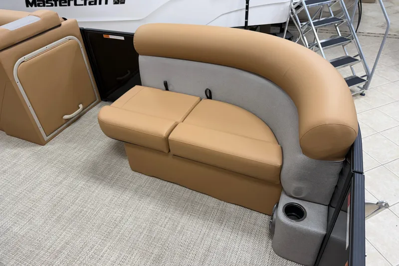 Slide: The Image of 2026 Crest Conquest SE 200 Cruise boat interior with tan seating and cup holder. - 3