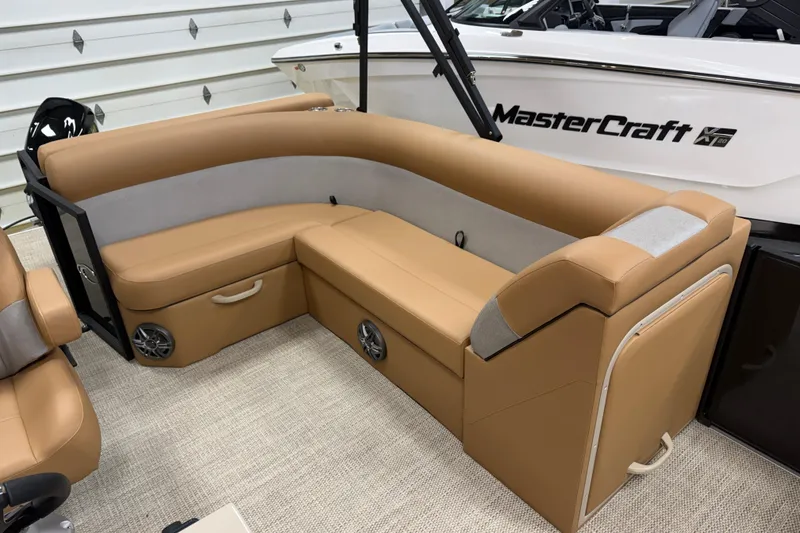 Slide: The Image of Luxurious seating on 2026 Crest Conquest SE 200 Cruise boat, featuring tan upholstery and modern design. - 4