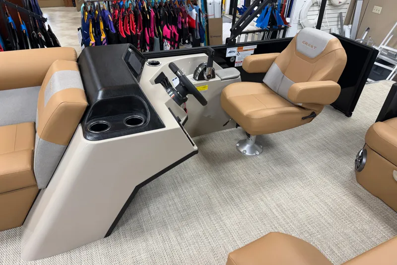 Slide: The Image of 2026 Crest Conquest SE 200 Cruise boat interior with tan seating and control console. - 5