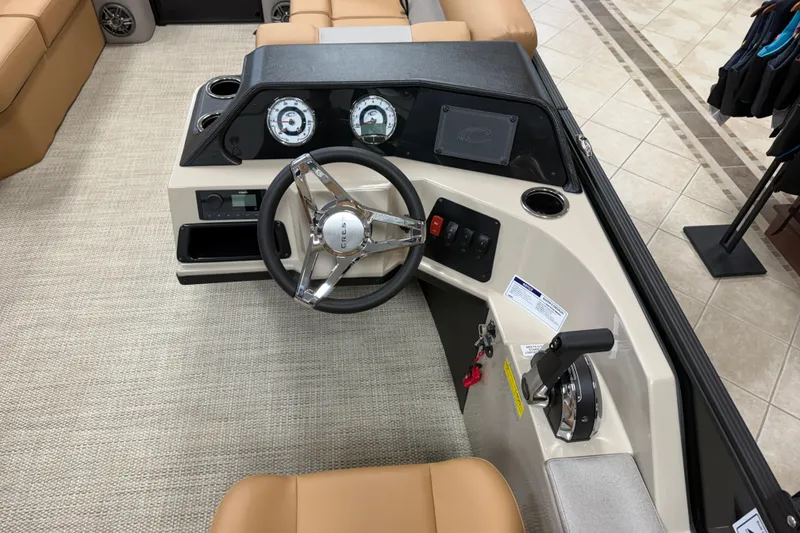 Slide: The Image of 2026 Crest Conquest SE 200 Cruise boat dashboard with steering wheel and controls. - 7
