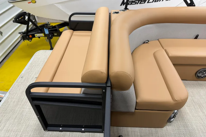 Slide: The Image of 2026 Crest Conquest SE 200 Cruise boat interior with tan seating and black railing. - 9