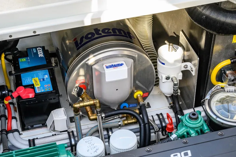 Slide: The Image of Engine compartment of 2023 Targa 27.2 boat with Isotemp water heater and Exide battery. - 12