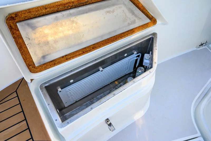 Slide: The Image of Built-in cooler on 2023 Targa 27.2 boat with drinks inside. - 17