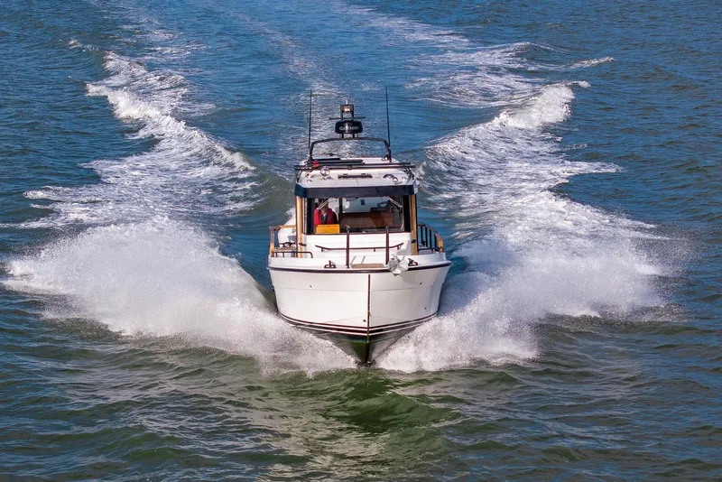 Slide: The Image of 2023 Targa 27.2 boat cruising on open water, creating a dynamic wake. - 2