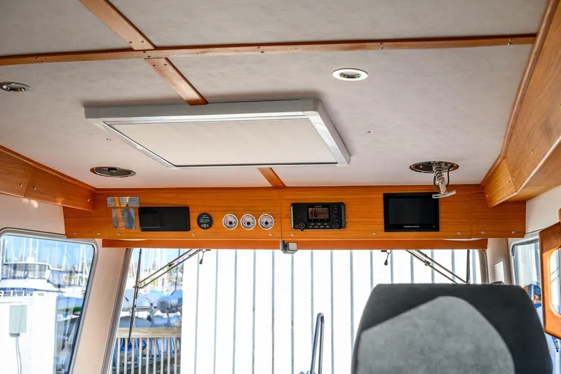 Slide: The Image of Interior of 2023 Targa 27.2 boat with control panel and wooden accents. - 24