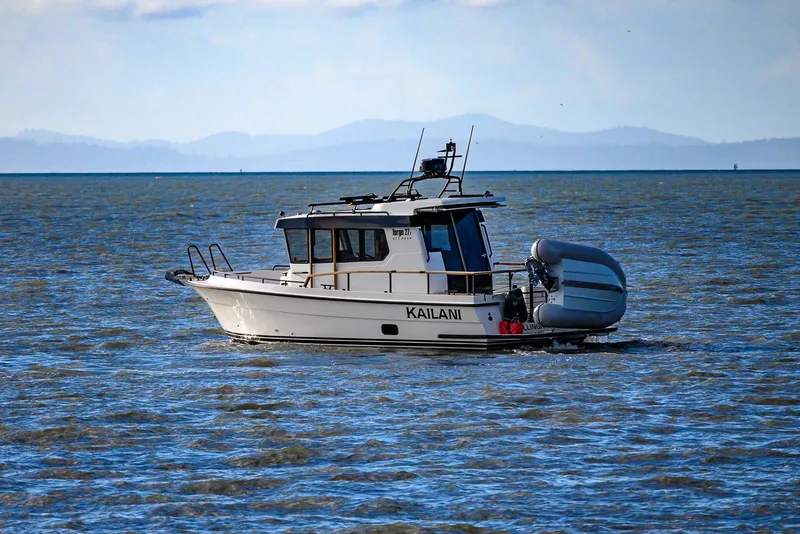 Slide: The Image of 2023 Targa 27.2 boat on open water with inflatable dinghy attached. - 35