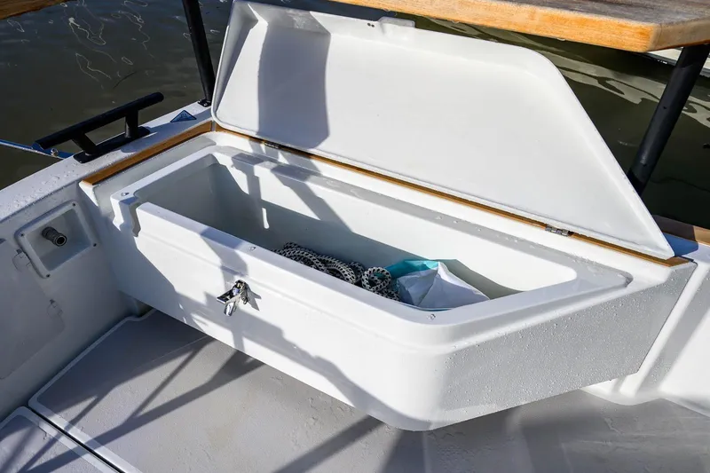 Slide: The Image of Open storage compartment on 2023 Targa 27.2 boat, showing interior space and contents. - 6