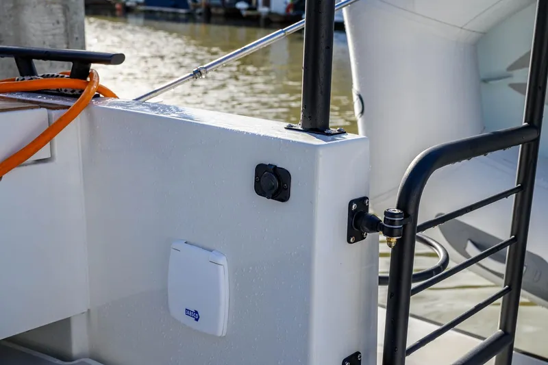 Slide: The Image of 2023 Targa 27.2 boat detail with railing and dockside view. - 8