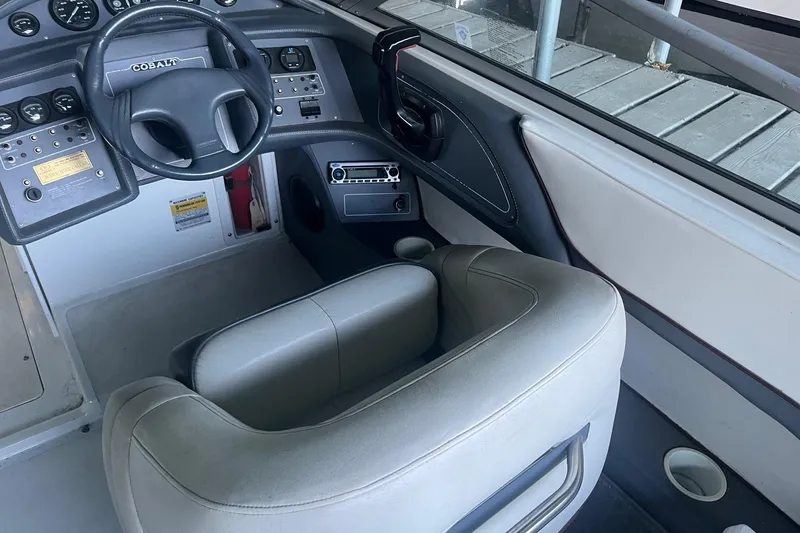 Slide: The Image of Interior of a 1995 Cobalt 252 boat, featuring steering wheel and control panel. - 11