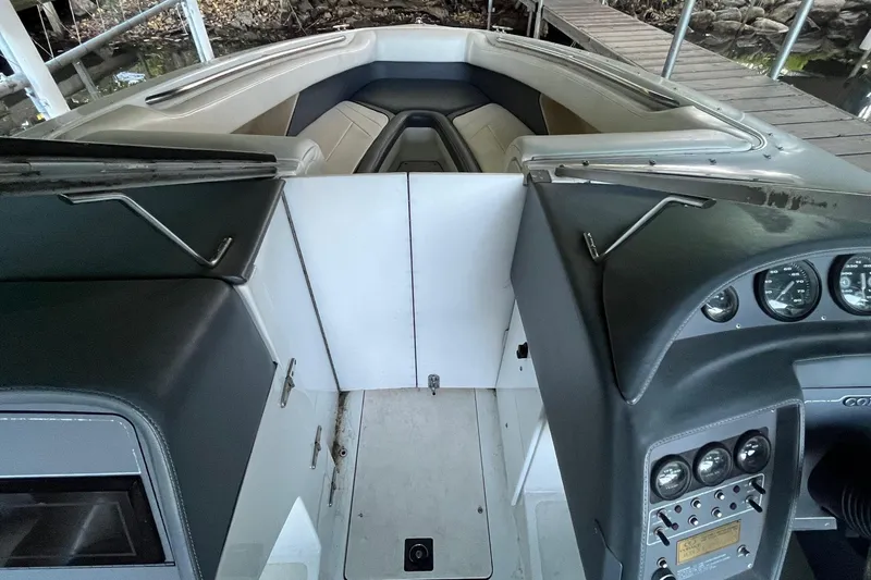 Slide: The Image of Interior view of a 1995 Cobalt 252 boat, featuring dashboard and seating area. - 17