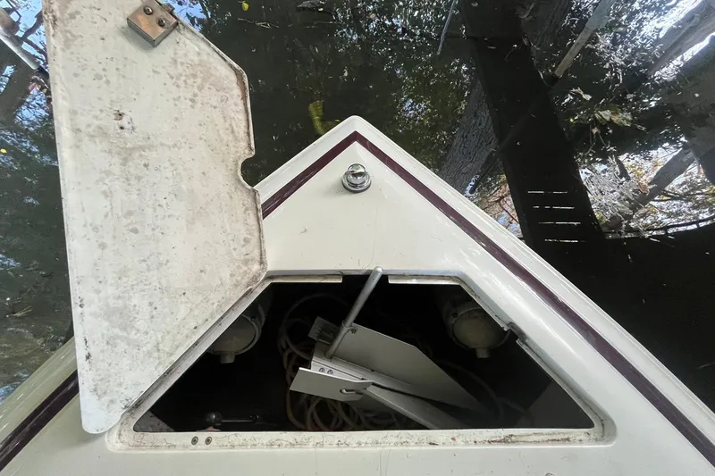Slide: The Image of Open storage compartment on 1995 Cobalt 252 boat, showing ropes and equipment inside. - 19