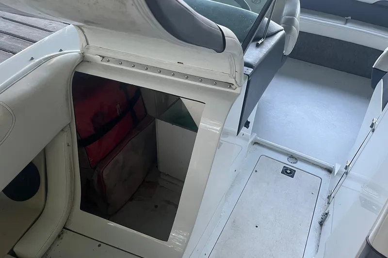 Slide: The Image of 1995 Cobalt 252 boat interior showing seating and storage compartment. - 21
