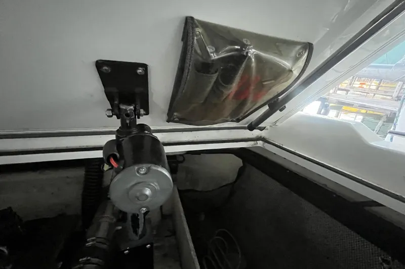 Slide: The Image of Interior view of a 1995 Cobalt 252 boat showing mechanical components and a window. - 24