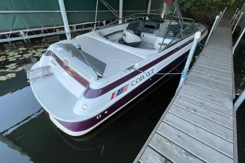 Slide: The Image of 1995 Cobalt 252 boat docked, featuring a sleek design and spacious interior. - 3