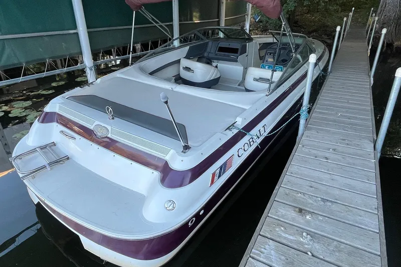 Slide: The Image of 1995 Cobalt 252 boat docked beside a wooden pier. - 4