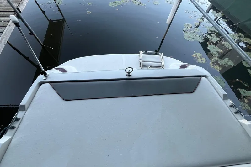 Slide: The Image of 1995 Cobalt 252 boat stern with swim platform and ladder by the dock. - 7