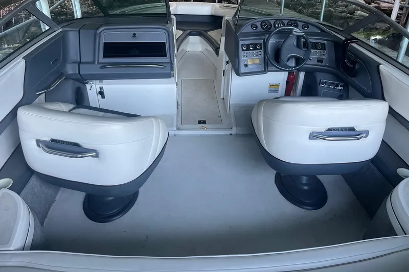 Slide: The Image of Interior of a 1995 Cobalt 252 boat with white seating and control panel. - 8