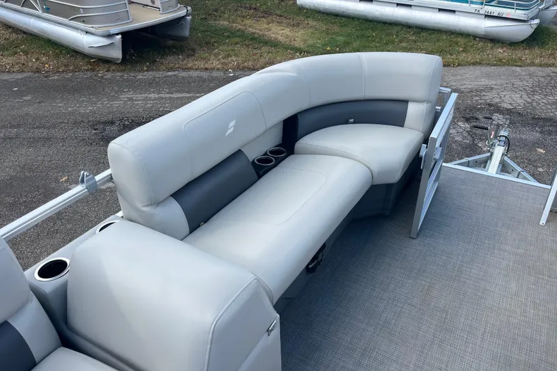 Slide: The Image of 2024 Starcraft LX 16 R pontoon boat with gray seating and cup holders. - 2