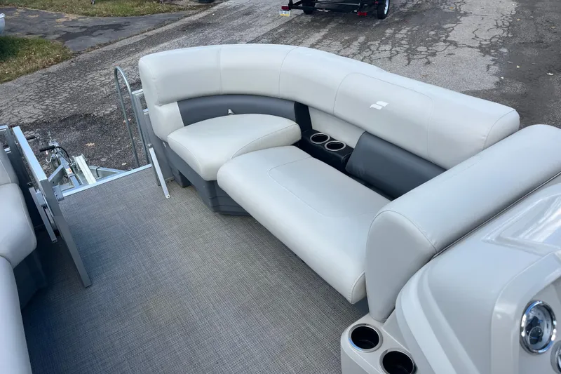 Slide: The Image of 2024 Starcraft LX 16 R boat interior with plush seating and cup holders. - 3