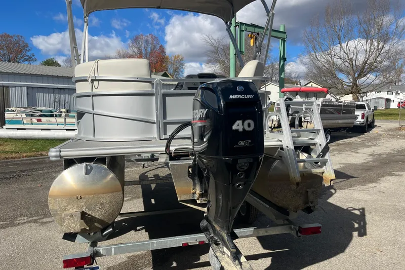 Slide: The Image of 2024 Starcraft LX 16 R pontoon boat with Mercury 40 HP engine on trailer. - 9