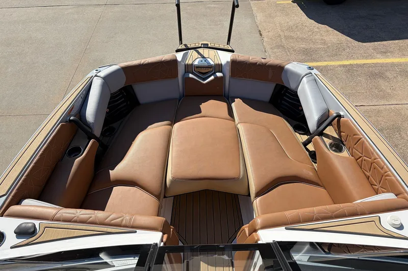 Slide: The Image of 2022 Nautique Super Air Nautique G25 Paragon boat interior with luxurious tan seating. - 13