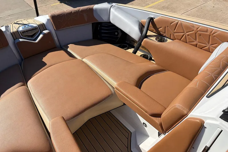 Slide: The Image of 2022 Nautique Super Air Nautique G25 Paragon interior with luxurious brown seating. - 17