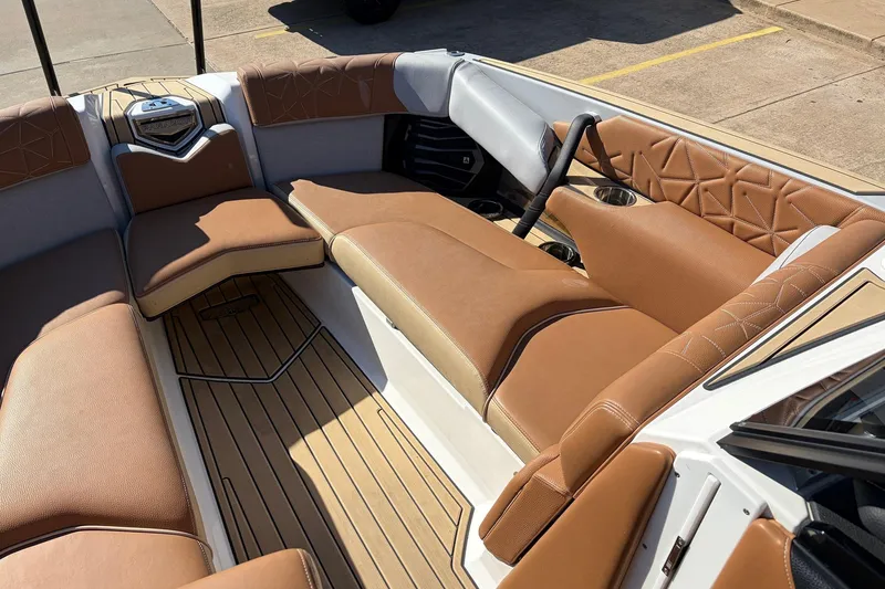 Slide: The Image of 2022 Nautique Super Air Nautique G25 Paragon interior with tan leather seating and wood flooring. - 19
