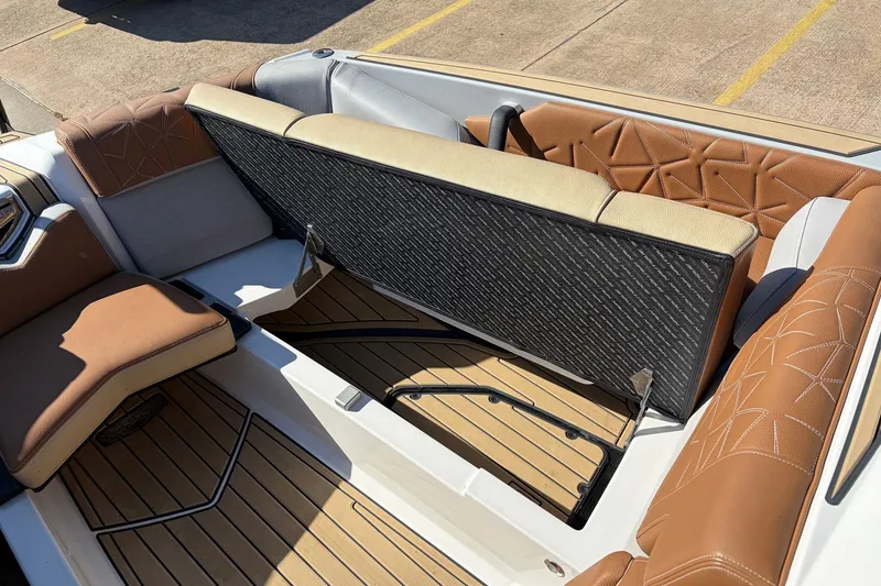 Slide: The Image of 2022 Nautique Super Air Nautique G25 Paragon interior with tan seating and storage compartment. - 21