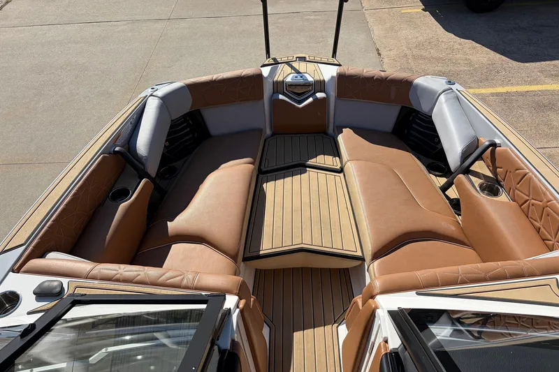 Slide: The Image of 2022 Nautique Super Air Nautique G25 Paragon boat interior with tan leather seating. - 22