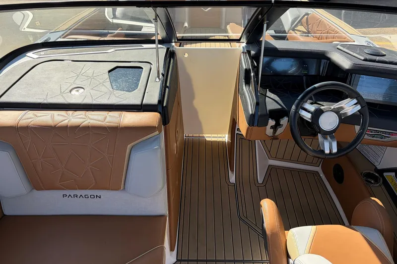 Slide: The Image of 2022 Nautique Super Air Nautique G25 Paragon interior with luxury seating and modern dashboard. - 23
