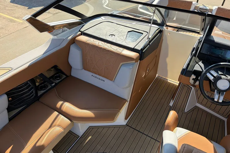 Slide: The Image of 2022 Nautique Super Air Nautique G25 Paragon interior with luxurious seating and modern dashboard. - 24