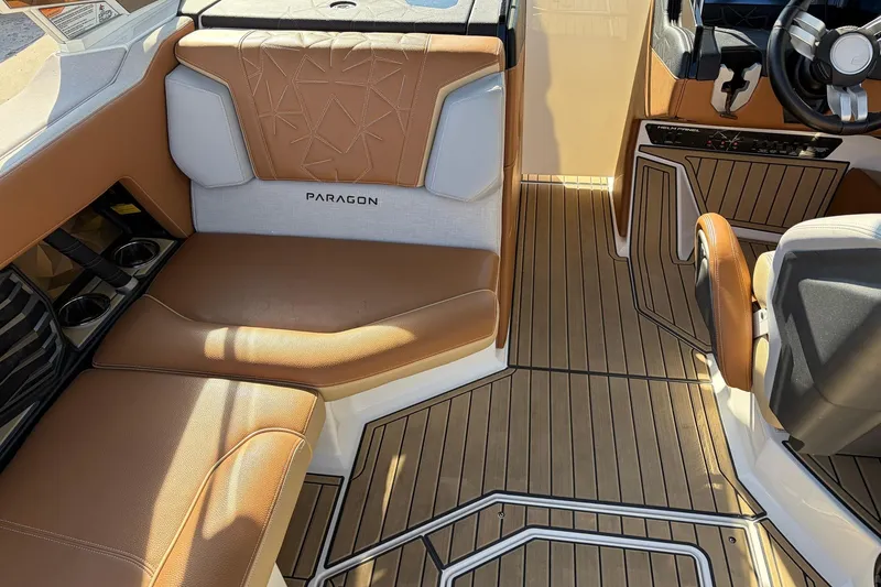 Slide: The Image of 2022 Nautique Super Air Nautique G25 Paragon interior with tan leather seating and wood flooring. - 28
