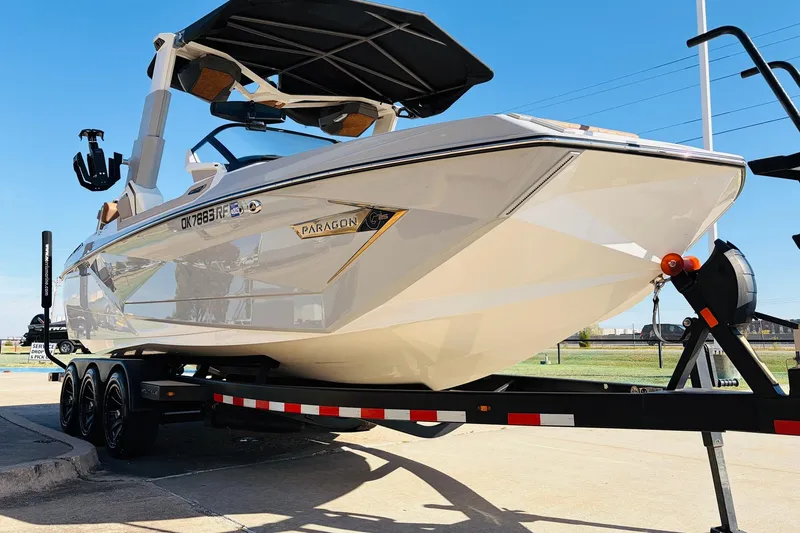 Slide: The Image of 2022 Nautique Super Air Nautique G25 Paragon on trailer, sleek design, sunny day. - 3