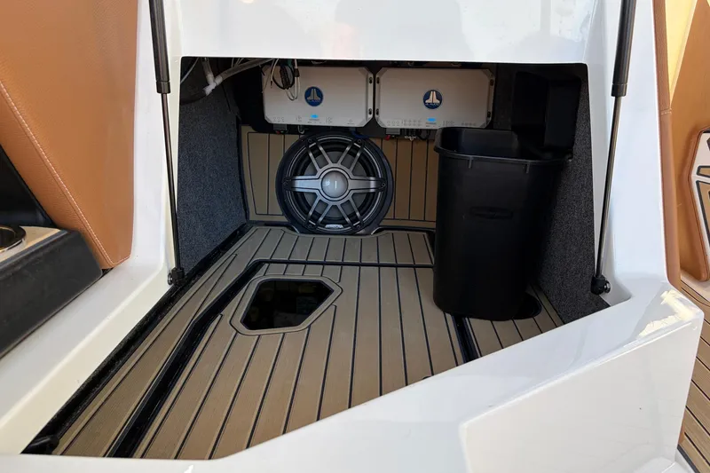 Slide: The Image of 2022 Nautique Super Air Nautique G25 Paragon storage compartment with speaker and equipment. - 30