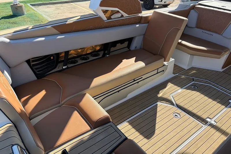 Slide: The Image of 2022 Nautique Super Air Nautique G25 Paragon interior with tan seating and teak flooring. - 35