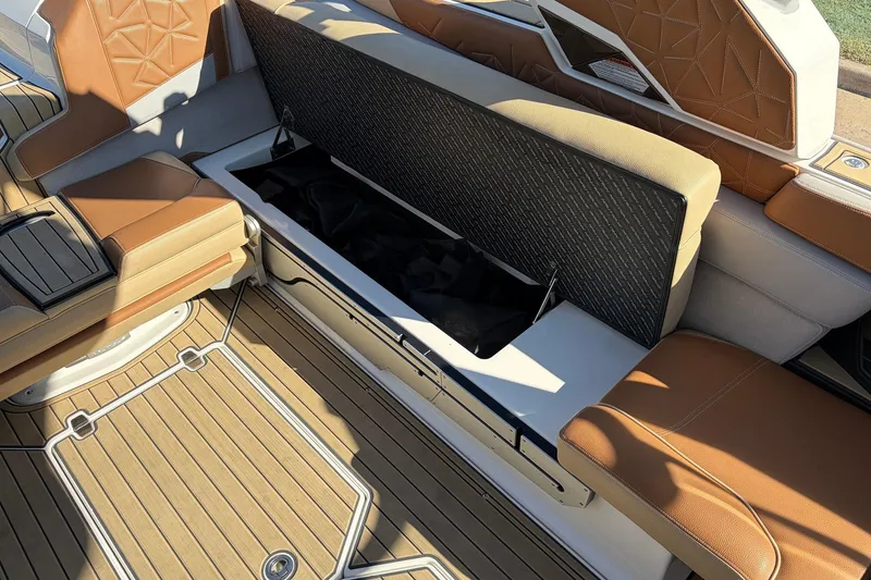 Slide: The Image of 2022 Nautique Super Air Nautique G25 Paragon interior with open storage compartment. - 36