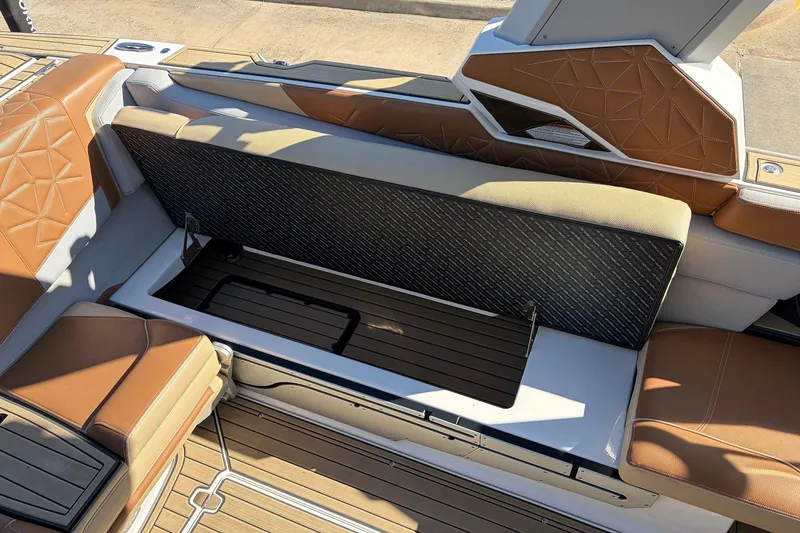 Slide: The Image of 2022 Nautique Super Air Nautique G25 Paragon interior seating with storage compartment open. - 37