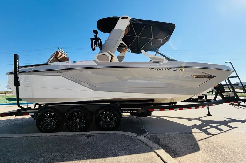 Slide: The Image of 2022 Nautique Super Air Nautique G25 Paragon boat on trailer, side view. - 4