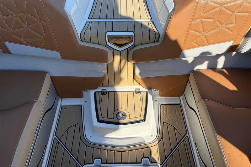 Slide: The Image of 2022 Nautique Super Air Nautique G25 Paragon interior with tan and white seating, teak flooring. - 45