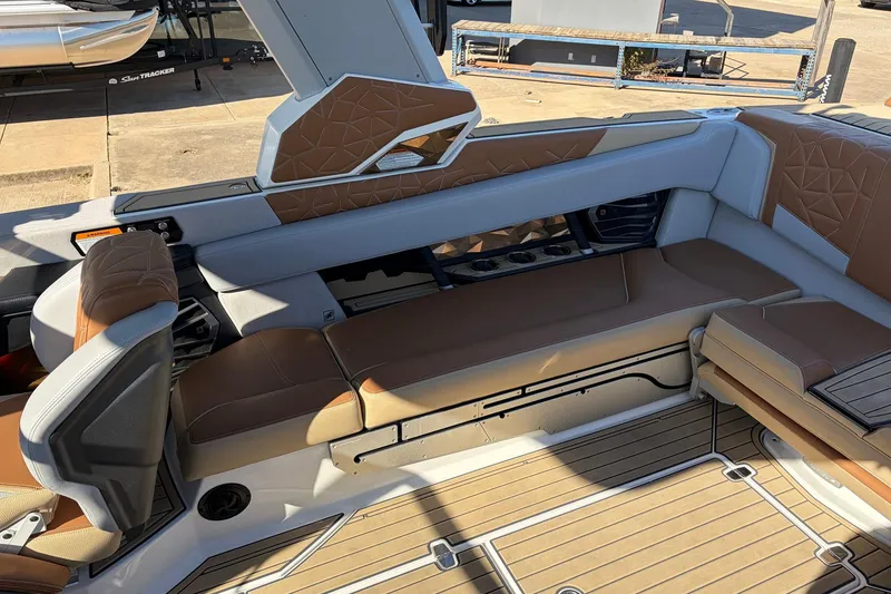 Slide: The Image of 2022 Nautique Super Air Nautique G25 Paragon interior with tan and gray seating. - 47