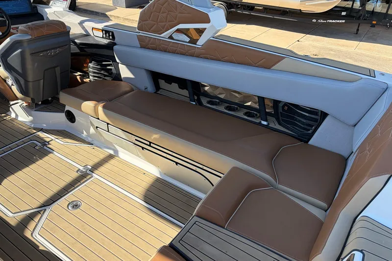 Slide: The Image of 2022 Nautique Super Air Nautique G25 Paragon interior with tan and gray seating. - 49