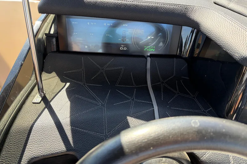 Slide: The Image of 2022 Nautique Super Air Nautique G25 Paragon dashboard with digital display and leather accents. - 54