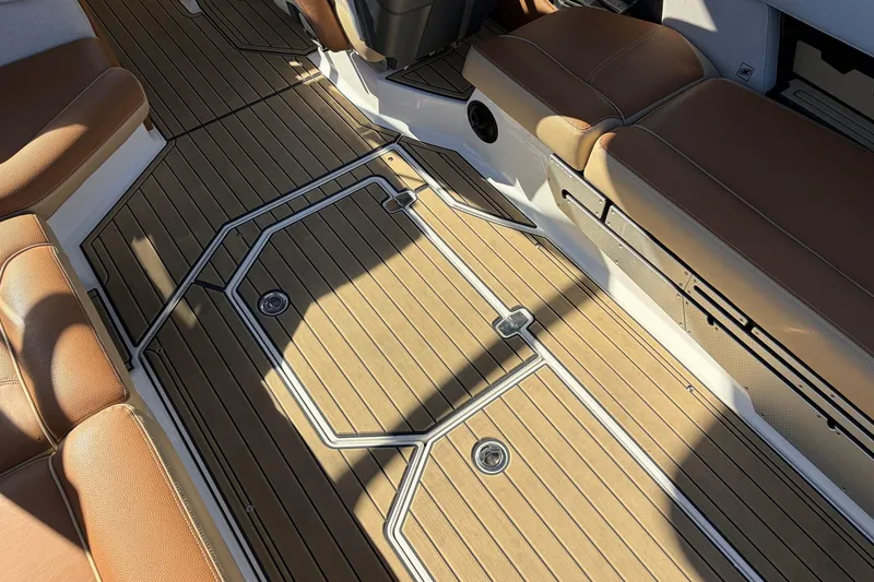 Slide: The Image of 2022 Nautique Super Air Nautique G25 Paragon interior with brown seating and teak-style flooring. - 67