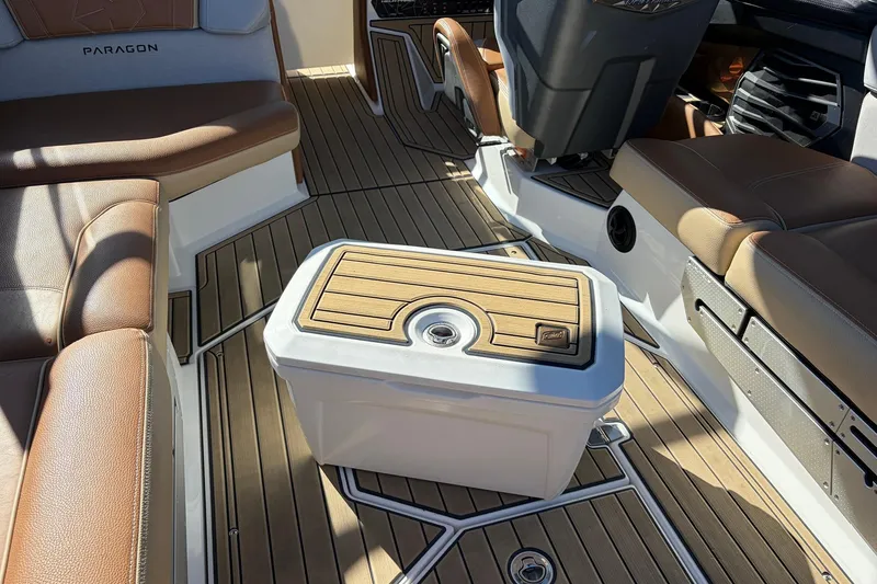 Slide: The Image of 2022 Nautique Super Air Nautique G25 Paragon interior with brown seating and wooden flooring. - 69
