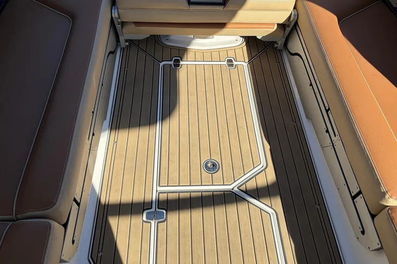 Slide: The Image of 2022 Nautique Super Air Nautique G25 Paragon interior with teak flooring and tan seating. - 71