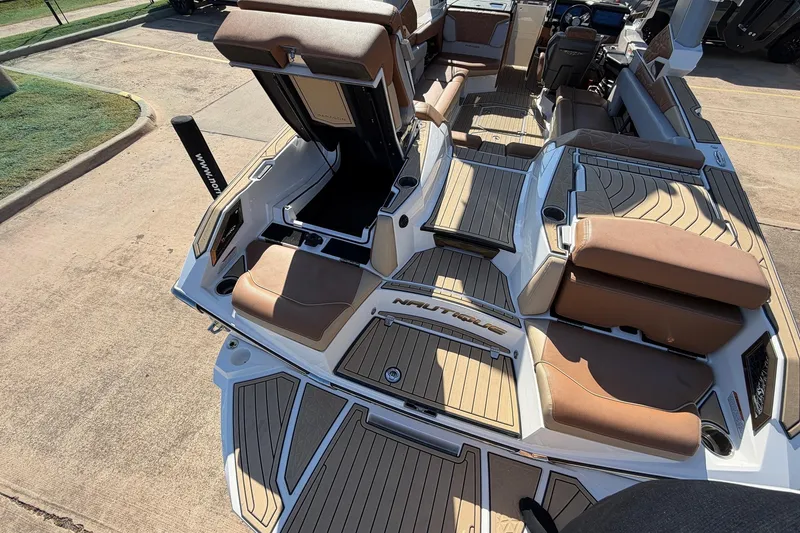 Slide: The Image of 2022 Nautique Super Air Nautique G25 Paragon boat interior with brown seating and deck. - 75